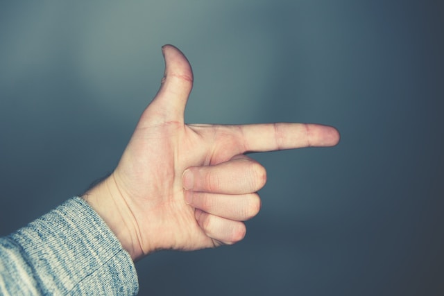 What does it mean when someone puts their index finger under their nose?