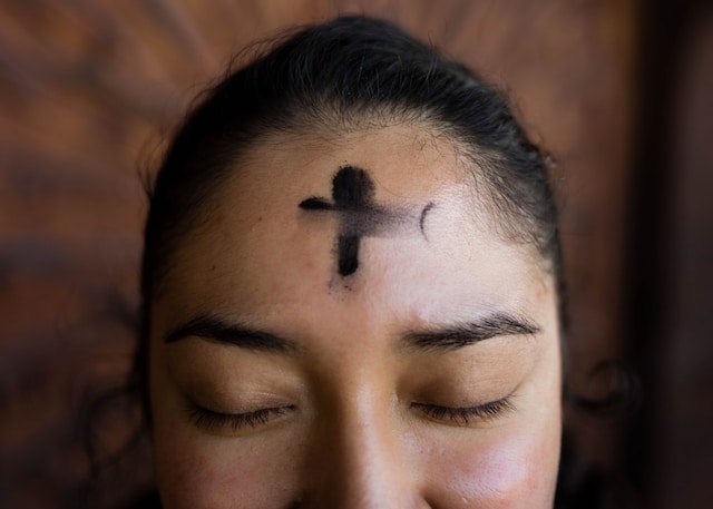 What does the cross in the middle of the forehead tattoo mean?