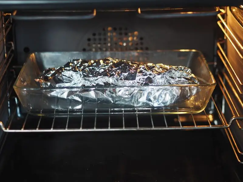 What does covering with a foil do in a oven?