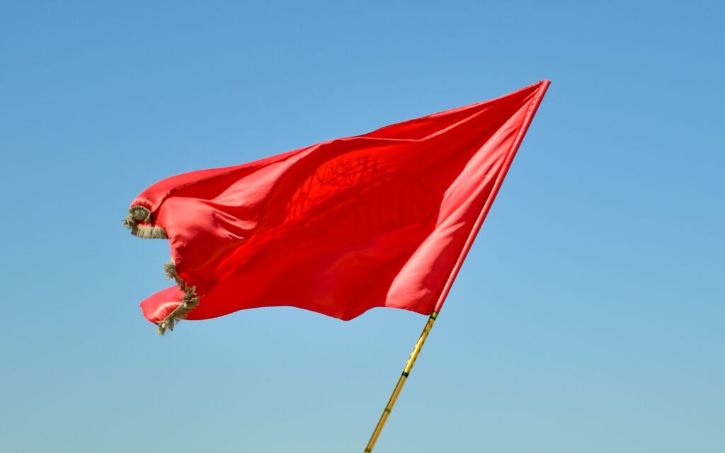 Which country flag has red in it?