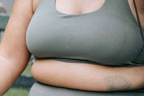What causes fat under breasts?